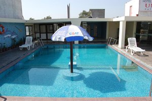 Hotel Unite in Pathankot, image may contain: Pool, Water, Villa, Chair