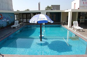 Hotel Unite in Pathankot, image may contain: Pool, Water, Villa, Chair
