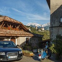 The metaphor of South Tyrol: the castle high between German car and Italian scooter :)