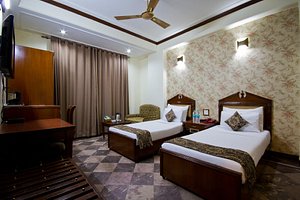 Hotel Sunstar Grand in New Delhi, image may contain: Ceiling Fan, Hotel, Resort, Bed