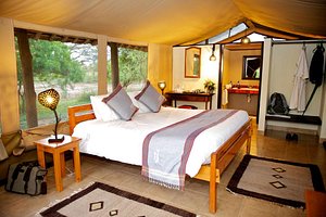 Voyager Ziwani Camp in Tsavo National Park West, image may contain: Resort, Home Decor, Bed, Furniture