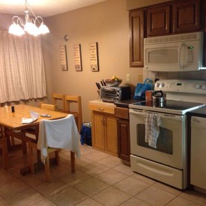 Modern and clean kitchen with cupboards stacked with pots, pans and everything nice.