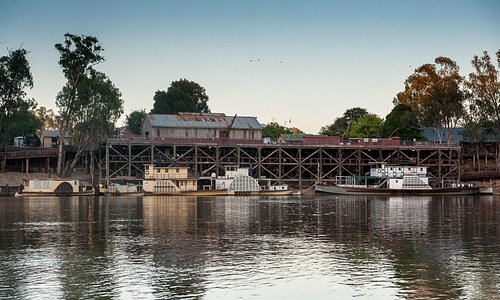 Early morning on the magic Murray River viewing the historic wharf and moored paddlesteamers