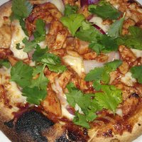 Delicious BBQ chicken pizza with fresh cilantro and red onion