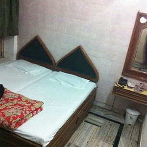Hotel Sakura in Agra, image may contain: Cushion, Table Lamp, Lamp, Furniture
