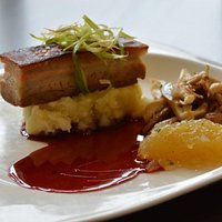 Crispy Godshill Pork belly and wild mushrooms finished with a red wine jus