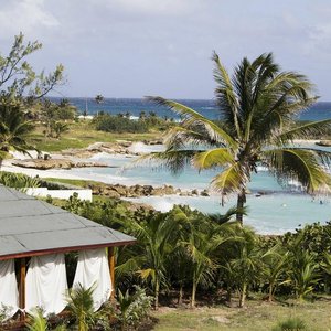 Ocean Spray Beach Apartments in Barbados, image may contain: Balcony, Summer, Scenery, Chair