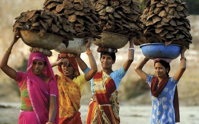 The art of balancing the large piles of gobar(cow dung) on their heads!