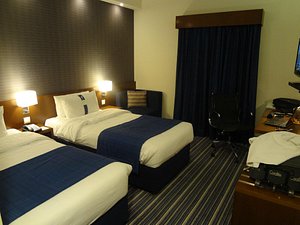 Holiday Bahrain Hotel in Manama, image may contain: Chair, Furniture, Bed, Bedroom