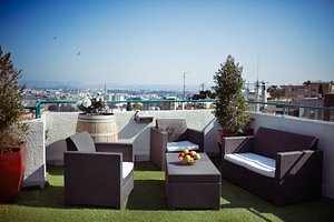 Loui M Apartments in Haifa, image may contain: Balcony, Terrace, Couch, Plant