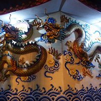 Chinese style reliefs on the outer wall of Wat Chana Songkhram