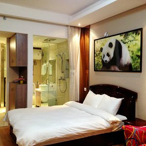Chengdu Panda Apartment in Chengdu, image may contain: Bed, Cushion, Interior Design, Monitor