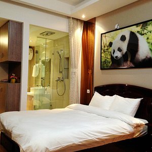 Chengdu Panda Apartment in Chengdu, image may contain: Bed, Cushion, Interior Design, Monitor