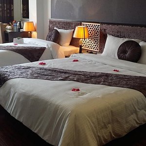 Golden Sun Suites Hotel in Hanoi, image may contain: Furniture, Bed, Home Decor, Cushion