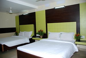 MGR Regency Comfort Hotel in Pondicherry, image may contain: Furniture, Bed, Bedroom, Room