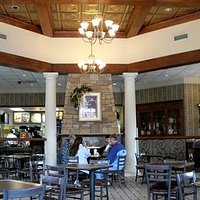This pic shows the fireplace, columns, lighting and ceiling.