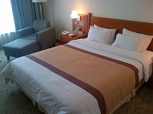 Hotel Paragon in Busan, image may contain: Bed, Furniture, Bedroom, Chair