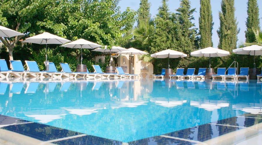 Pool: Lush green gardens surround the swimming pool.