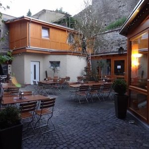 The pretty beer garden under the 15th century town wall