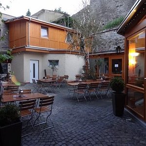 The pretty beer garden under the 15th century town wall