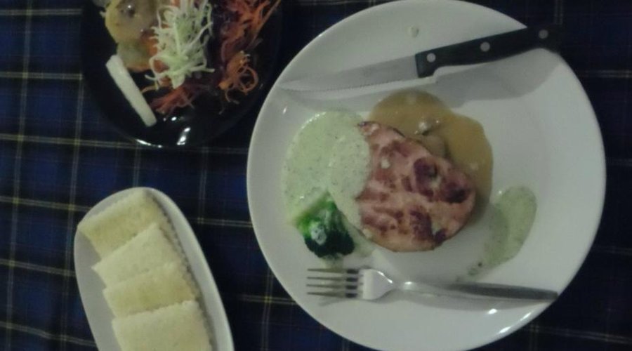 Ham steak with garlic bread as a side order and salad from salad bar