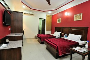 Hotel Maharaja Residency in Jalandhar, image may contain: Furniture, Bedroom, Bed, Monitor