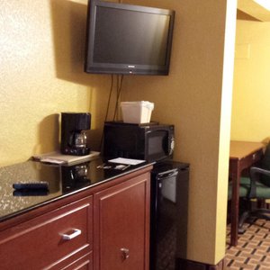 Flat screen tv, microwave and fridge.
