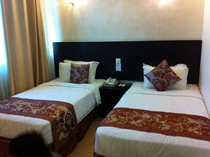 My Inn Hotel in Lahad Datu, image may contain: Cushion, Person, Bed, Furniture