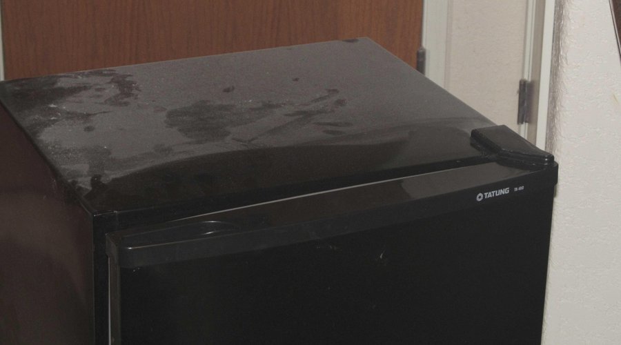 Dusty, broken fridge.