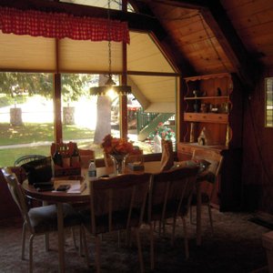 Dining area off kitchen area with one way windows and pull blinds