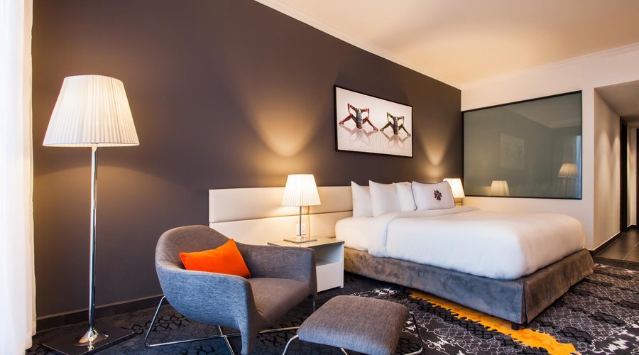 Deluxe one king bed. In-Room amenities include Lather Aromatherapy products, Nespresso machine.