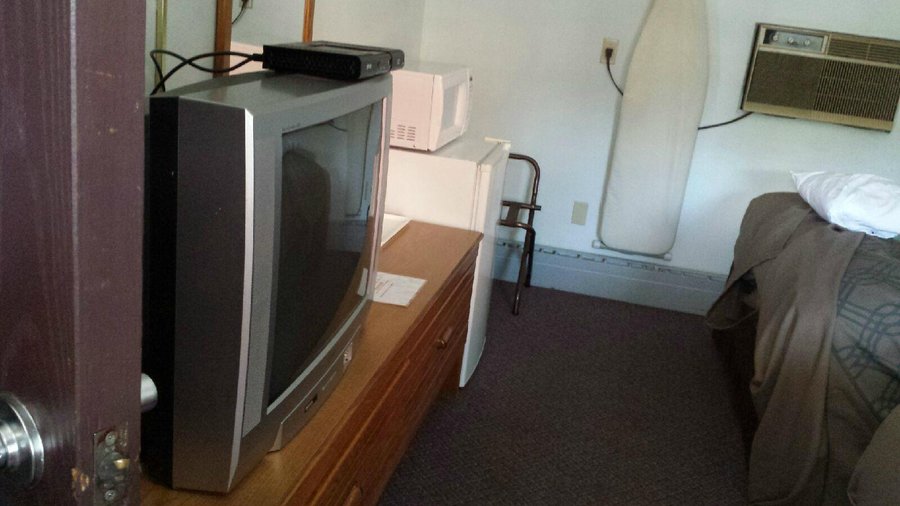 tv, fridge, and microwave in room