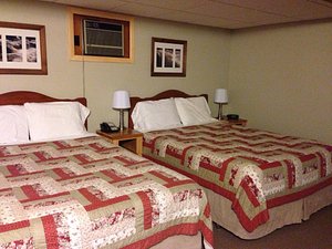 Northshore Motel in Manistique, image may contain: Lamp, Bed, Furniture, Painting