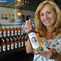 Owner, Eugenia Motte with a bottle of The General