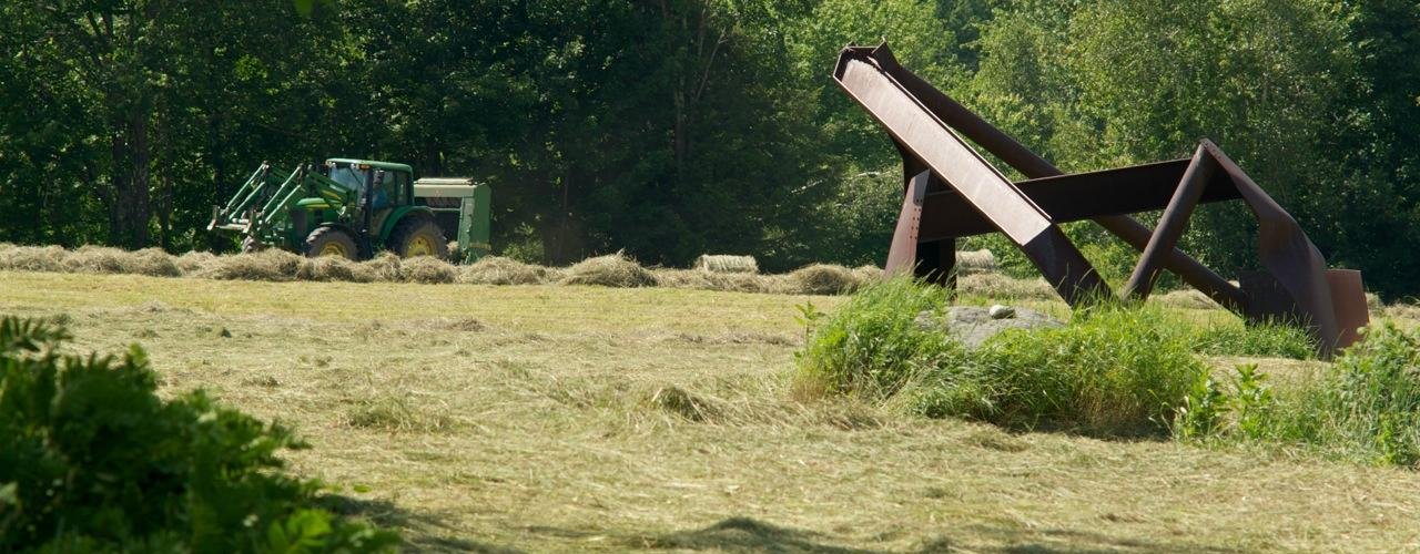 Our neighbor using Cold Hollow Sculpture Park fields for his family farm.