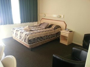 Wattle Tree Motel in Cootamundra, image may contain: Furniture, Bed, Dorm Room, Bedroom