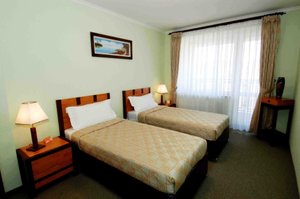 Narantuul Hotel in Ulaanbaatar, image may contain: Furniture, Bed, Lamp, Bedroom