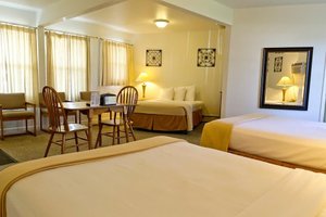 Sunset Lodge Escanaba in Escanaba, image may contain: Hotel, Chair, Furniture, Bed