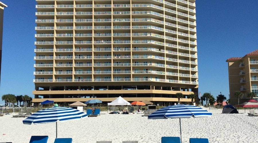 view of Seawinds from beach (401 is first balocny above parking garage  on far right