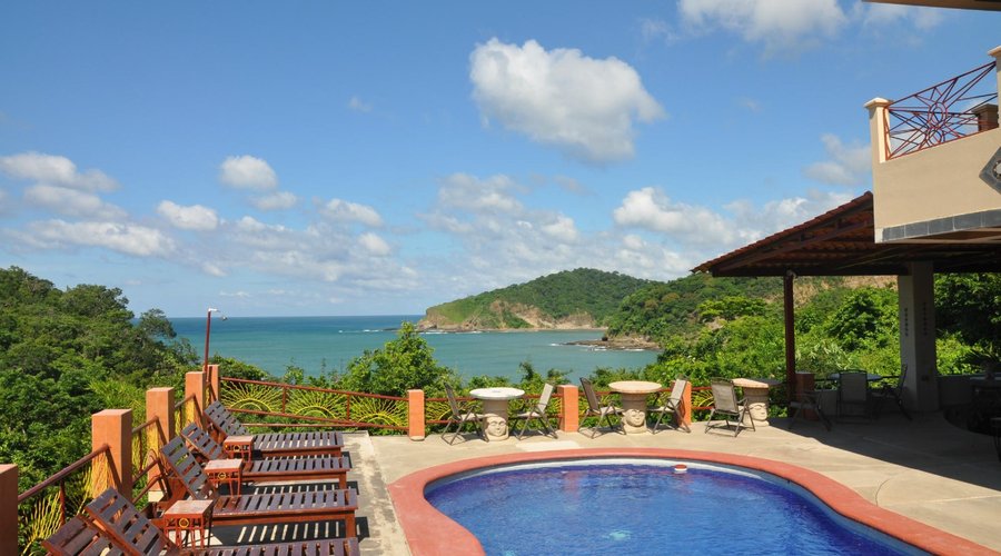 Looking at the pool and the sea from the shaded hammock area