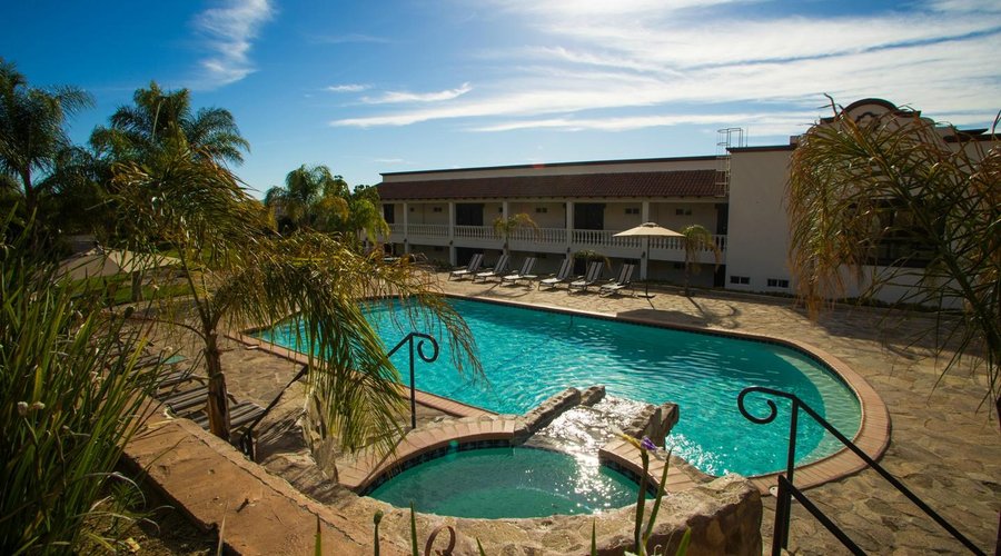 Back side of hotel. Room entrances. Pool & jaccuzi area.