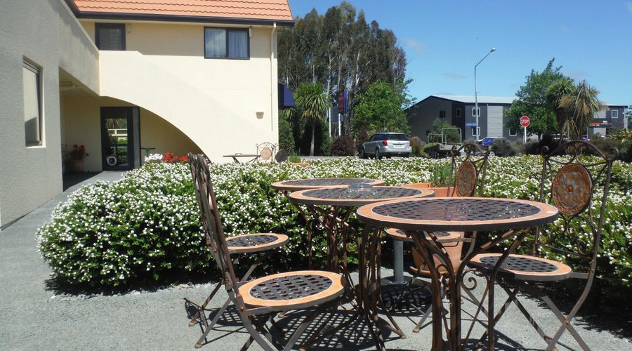 Coutyard with Mediterranean tables and chairs where guests like to sit  and smell the lavender