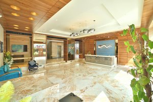 Hotel G Express in Ahmedabad, image may contain: Floor, Flooring, Interior Design, Chair