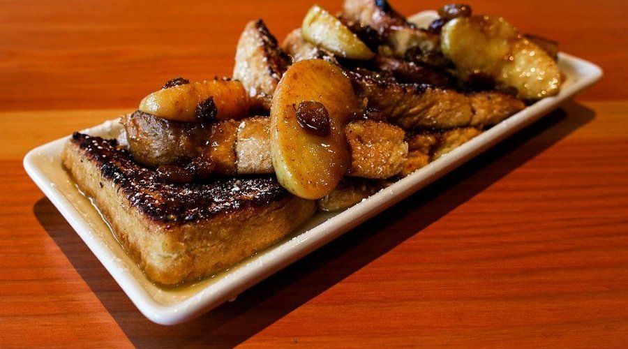 Thick sliced French Toast with local apples, golden raisins, and bourbon caramel sauce.