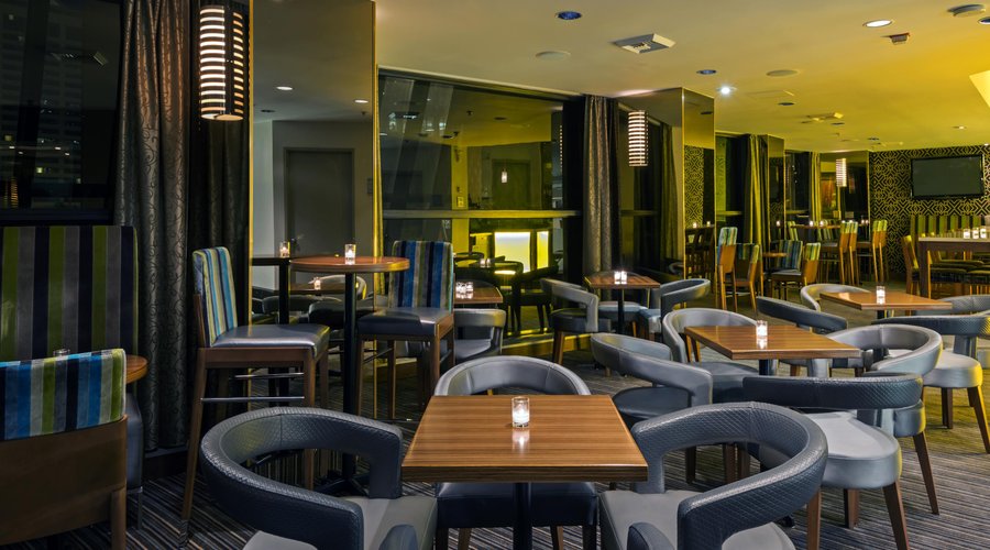 Unwind with your favorite cocktail while watching the game on two giant plasma TVs