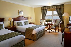 Dingle Skellig Hotel & Peninsula Spa in Dingle, image may contain: Bed, Furniture, Chair, Table Lamp