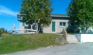Commando Motel in Cochrane, image may contain: Neighborhood, Shelter, Backyard, Yard