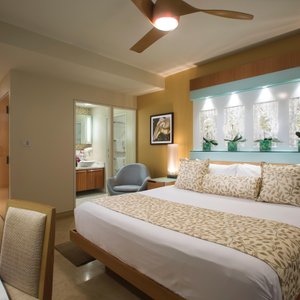Santa Maria Suites Hotel in Key West, image may contain: Ceiling Fan, Electrical Device, Bed, Furniture