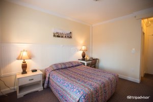 The Grant Hotel in San Francisco, image may contain: Furniture, Bed, Lamp, Bedroom