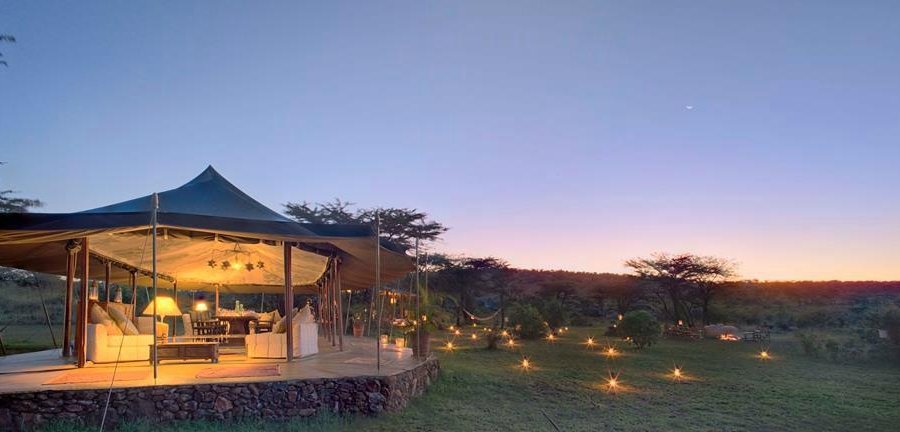 Lanterns across the lawn and the dining tent